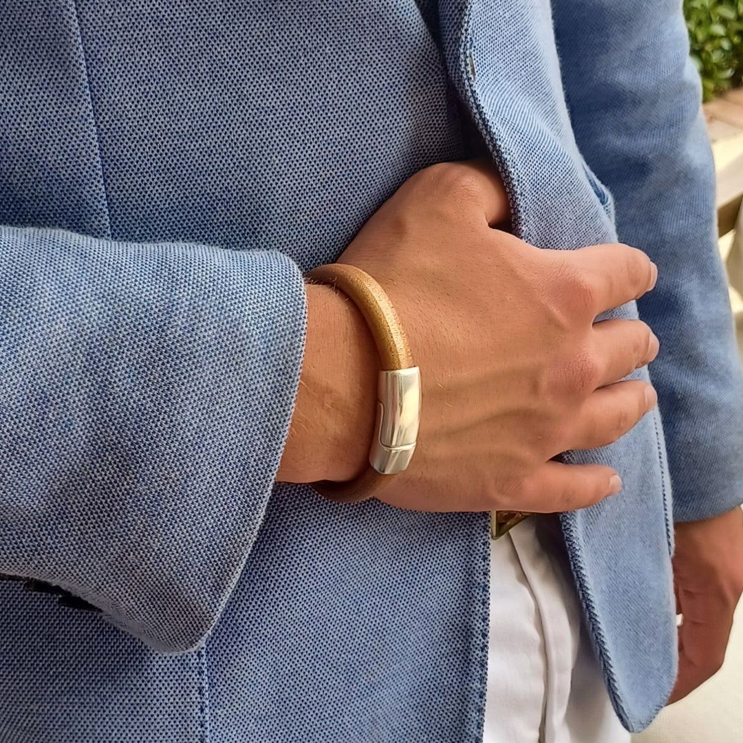 Close-up of a man wearing a Bronze leather bracelet with a blue jacket. Cobo bracelet lifestyle photo. 
